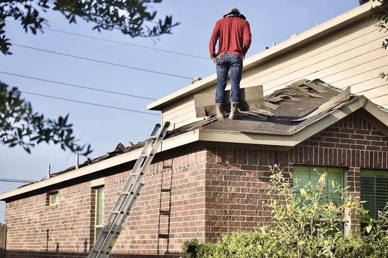 Professional roofer working on a residential roof in Strasburg Junction